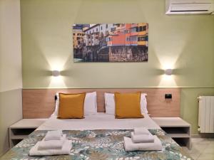 Postel nebo postele na pokoji v ubytování Hotel Camilla Guelfa