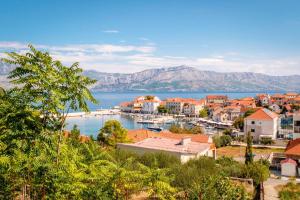 a view of a town with a harbor and the water at Spacious one bedroom apartment Lana in Postira