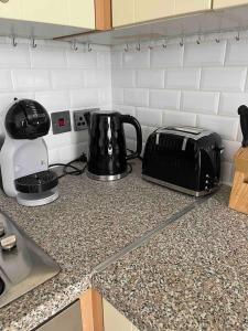 a kitchen counter with a toaster and a toaster on a counter top at Quiet and cozy 2 SEPERATE BEDROOMS and 2 BATHROOM with terrace in London