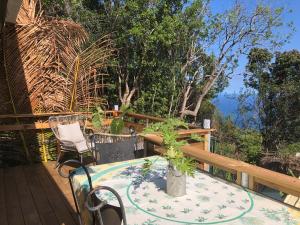 eine Terrasse mit einem Tisch und Stühlen auf einer Terrasse in der Unterkunft Bungalow 4 épices in Saint-Leu