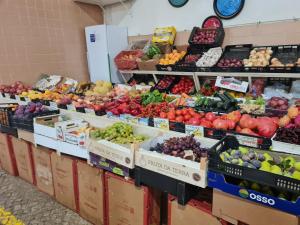 a produce section of a grocery store with fruits and vegetables at VILLA DO LIMAO in Tavira