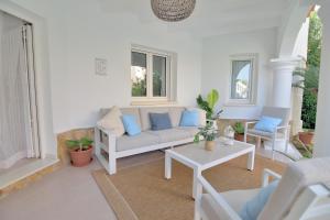 a living room with a couch and two chairs at Villa Renoir by Goveralia in Oliva +36 photos