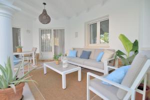 a living room with a couch and a table at Villa Renoir by Goveralia in Oliva