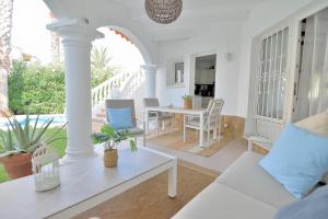 a living room with a table and chairs at Villa Renoir by Goveralia in Oliva