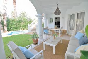 a living room with a couch and a table at Villa Renoir by Goveralia in Oliva
