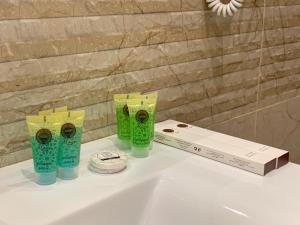a white sink with three cups on top of it at Friday Suites in AlUla