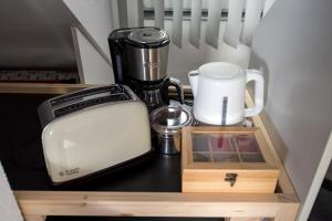 a kitchen counter with a coffee maker and a toaster at Ferienwohnung Regel in Lauingen
