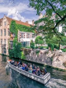 um grupo de pessoas em um barco em um rio em B&B Barabas em Bruges