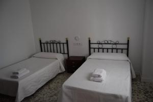 two beds sitting next to each other in a room at CASA DEL RIO in Castril