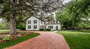 a brick driveway in front of a white house at Woodbourne Inn in Niagara-on-the-Lake