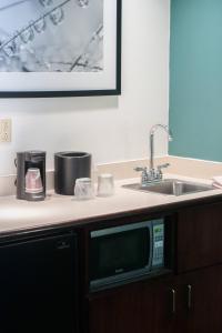 a kitchen counter with a sink and a microwave at SpringHill Suites Pittsburgh Monroeville in Monroeville