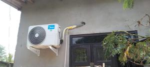 a fan is attached to the side of a house at Kitula family guest house in Anuradhapura