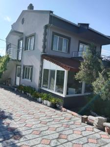 a house with a stone driveway in front of it at Çetin apart in Ezine