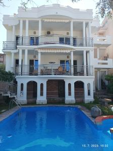 a large house with a swimming pool in front of it at Apartments Pekic in Bar