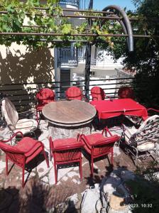 a group of red chairs and a table and chairs at Apartments Pekic in Bar