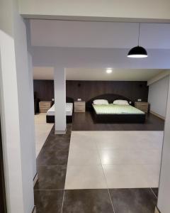 a bedroom with two beds and a ceiling at Нашата къща "our house" in Pomorie