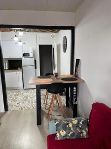 a living room with a table and a kitchen at Chez Laeti appartement type F2 in Fécamp