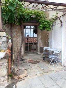 an entrance to a house with a table and a glass door at La Cannicciaia in Montale