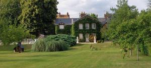 a large house with a grass yard in front of it at La petite sirène in Sahurs