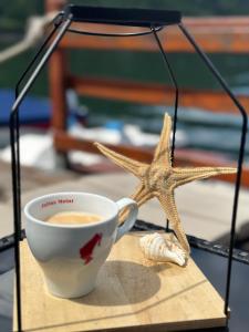 a cup of coffee and a starfish on a table at Sunset By The Lake Ponton Bicaz in Bicaz