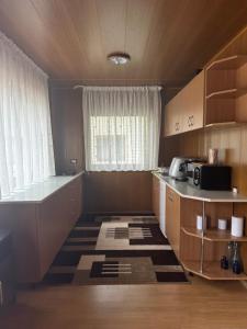 a small kitchen with a counter and a window at Sunset By The Lake Ponton Bicaz in Bicaz