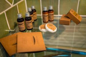 a group of bottles of honey on a glass table at Pensiunea Alessia Soveja in Soveja