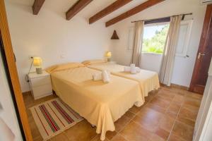 a bedroom with two beds and a window at Charming villa with A/C and WIFI in Pollença +32 photos