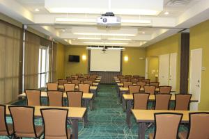 a lecture room with tables and chairs and a whiteboard at SpringHill Suites by Marriott Corpus Christi in Corpus Christi