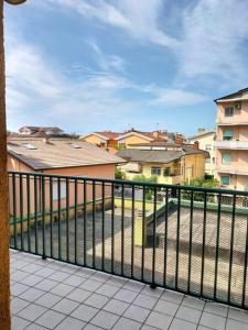 a balcony with a view of a city with buildings at Finestre Verdi appartamento con parcheggio in Ronchi dei Legionari