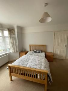 a bedroom with a wooden bed and a large window at Nharakat Mansion in Southampton