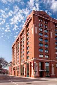 a large brick building on the corner of a street at SpringHill Suites by Marriott Dallas Downtown / West End in Dallas