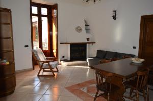 a living room with a table and a couch at La Petra in Vico Equense