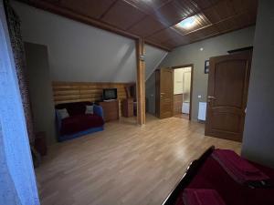 a bedroom with a bed and a wooden floor at "Діброва" in Yaremche