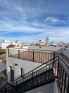 a balcony of a building with a view of a city at Duplex MC in Olavarría