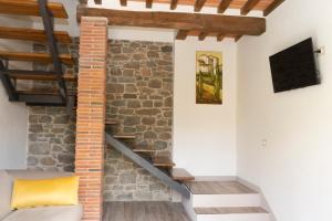 a staircase in a house with a brick wall at Casa vacanze Raggio di Sole in Grotte