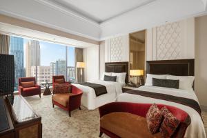 a hotel room with two beds and a large window at The St. Regis Chengdu in Chengdu