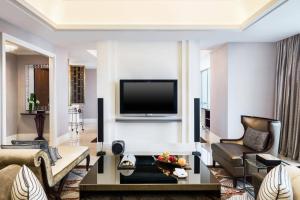 a living room with a flat screen tv on a wall at The St. Regis Chengdu in Chengdu