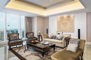 a living room with a couch and chairs and a table at The St. Regis Chengdu in Chengdu