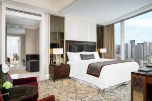 a bedroom with a large bed and a large window at The St. Regis Chengdu in Chengdu