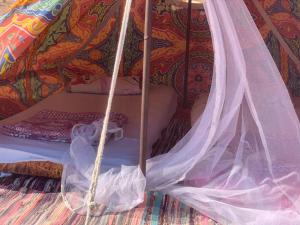 a bed in a tent with a canopy at Blend in Nature Camp in Sharm El Sheikh