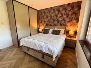 a bedroom with a large bed with a floral wallpaper at Penthouse Sarajevo in Sarajevo