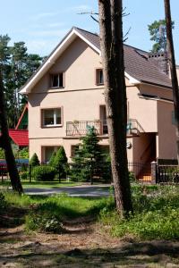 a house with a tree in front of it at Janina in Pobierowo