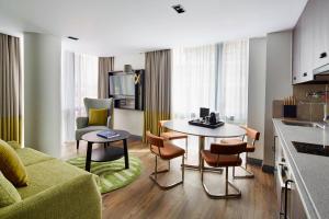 a living room with a couch and a table and chairs at Residence Inn by Marriott London Kensington in London