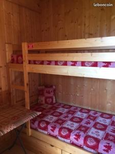 a room with two bunk beds in a cabin at Les Marmottes 18 C in La Chal