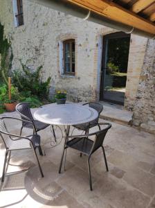 a table and chairs sitting on a patio at Saint Laurent in Portes-en-Valdaine