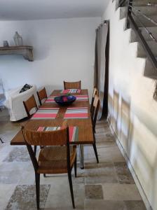 a dining room with a table and chairs at Saint Laurent in Portes-en-Valdaine