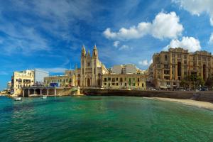 a view of a city with a river and buildings at Malta Marriott Resort & Spa in St. Julianʼs