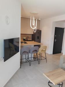 a kitchen and living room with a table and chairs at Apartments DiVi Sunset View in Mandre