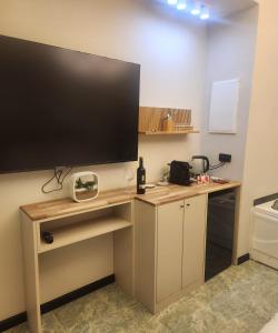 a desk with a large television on top of it at South Star Suites in Eilat