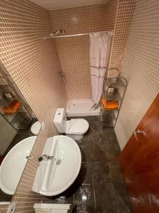 a bathroom with a white sink and a toilet at Precioso Piso en La Molina in La Molina
